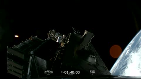 Satellite in orbit with bright sunlight reflecting off its panels.