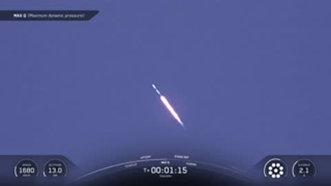 Rocket ascends through the upper atmosphere against a blue sky.