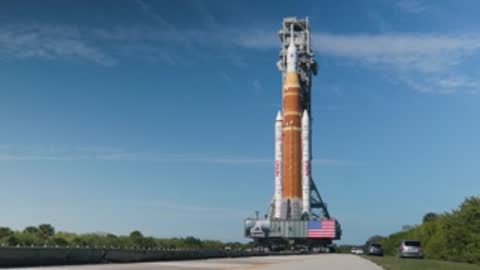 The crawler transporter slowly moves the SLS rocket along the road.