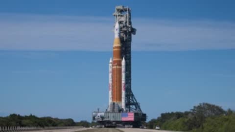 The SLS rocket and mobile launcher move along the crawlerway.