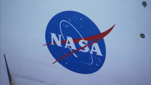 Close-up of the NASA blue meatball logo on a white surface.