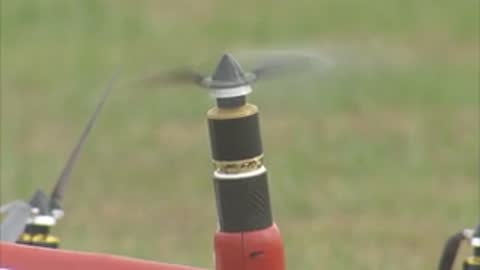 Close-up of a spinning propeller on a red vertical post of the aircraft.