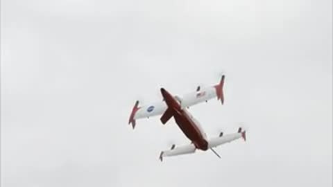 The aircraft ascends into the sky and transitions to forward flight.
