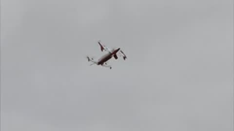The aircraft flies high in an overcast sky during testing.