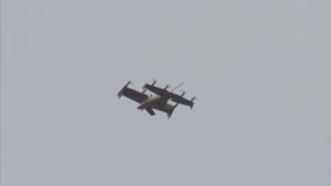 The aircraft maneuvers in the overcast sky during flight testing.