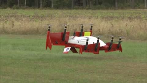 A drone landing on the grass in a field.