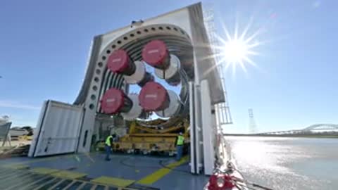 wide shot of a large barge opening its doors under a bright sunny sky