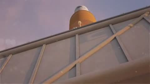 Medium animation panning up a rocket body near the gantry, period details.