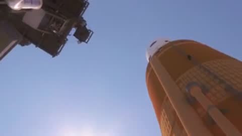 Wide animation looking up from the launch pad as the rocket ascends, period details.