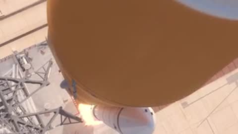 Close-up animation of the lower rocket section ascending past the tower, period details.