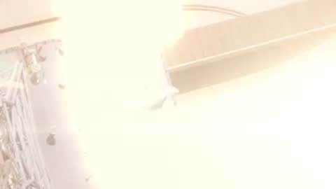 Close-up animation of intense rocket exhaust and bright light during liftoff, period details.