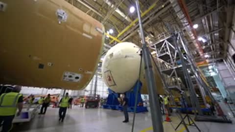 Close-up of two rocket components being brought together horizontally.