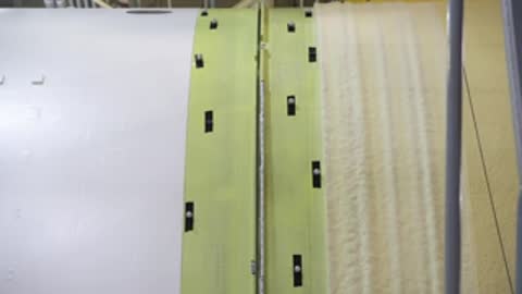 Close-up of joined panels on a rocket component with fastening hardware.