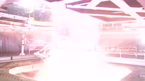 Engine test with bright orange flame illuminating the chamber floor.