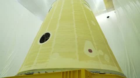 Inside view of the yellow cone-shaped launch vehicle stage adapter.