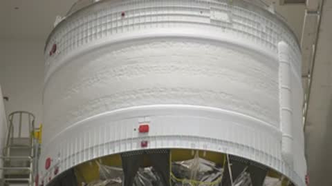 close up of cylindrical rocket part inside clean facility