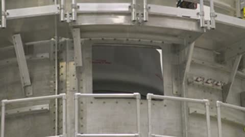 medium shot of structure framing interior rocket workshop