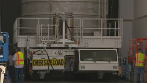 medium shot of oversized load transport truck moving outside