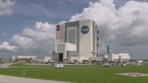 wide shot of large nasa building exterior with cloudy sky