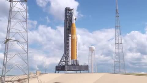 wide shot of complete rocket standing tall on launch pad structure