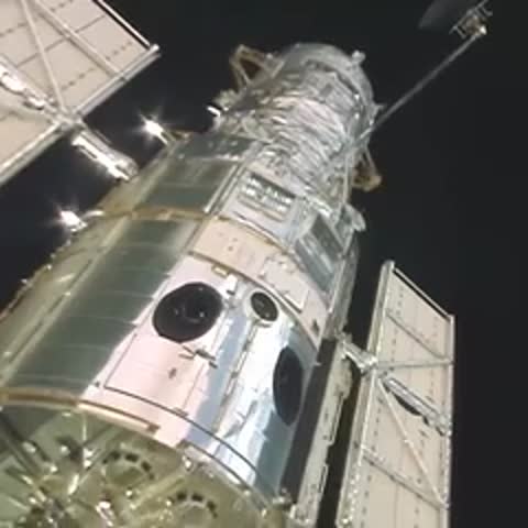 Hubble Space Telescope in orbit against the blackness of space.