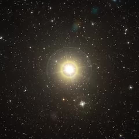 Close-up of a large telescope structure followed by a bright star with diffraction spikes.