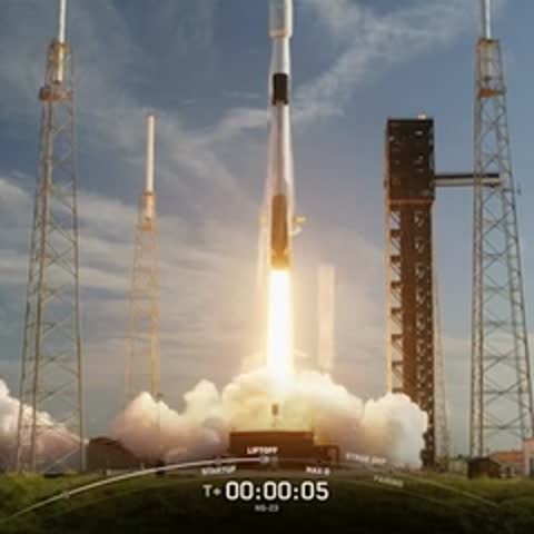 Rocket launching from launch pad with smoke and flames billowing out.