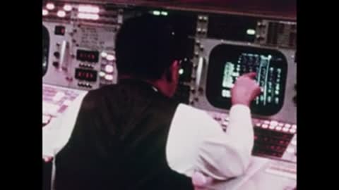 Over-the-shoulder shot of an operator looking at a green radar screen