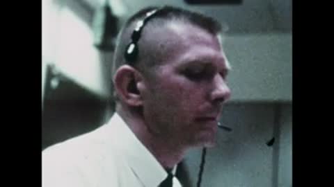 Close-up profile shot of a man wearing a headset in the control room