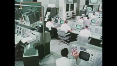 busy mission control room with engineers working at consoles