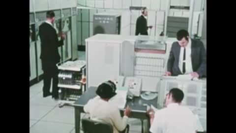 engineers in control room reviewing documents and equipment