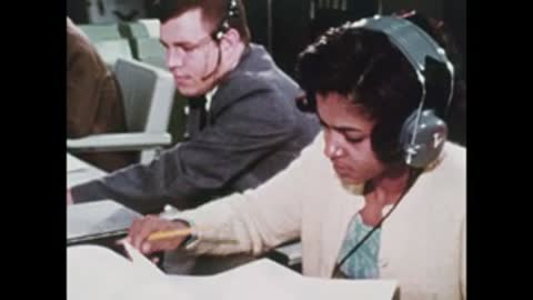 close-up of technicians working at desks with headsets
