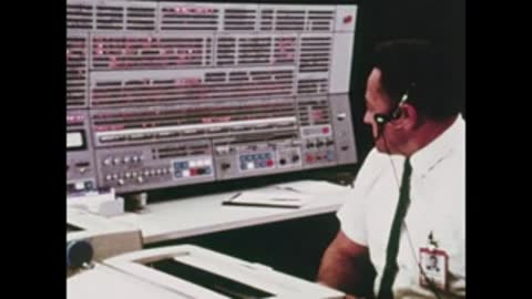 engineer wearing headset working at computer console