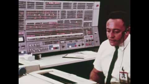 engineer wearing headset looking at computer console display