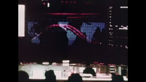 mission control room with large projected map display