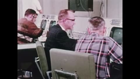 engineers working at computer consoles in control room
