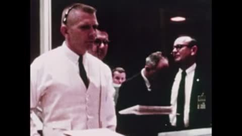 men in white shirts standing in mission control room
