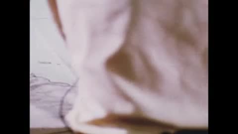 A close-up of a person examining a map on a table.