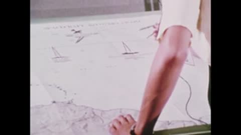 A person using drafting compasses on a map table.