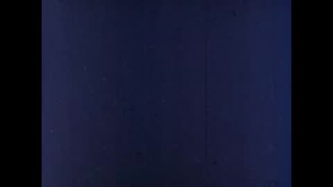 A dark, blank frame with faint texture and minimal light.