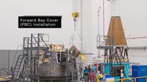 Wide view of facility as Forward Bay Cover FBC installation begins on spacecraft