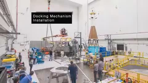 Docking Mechanism installation process inside spacecraft assembly clean room
