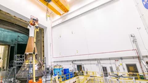 Orion spacecraft being pulled out of NASA acoustic test chamber into facility