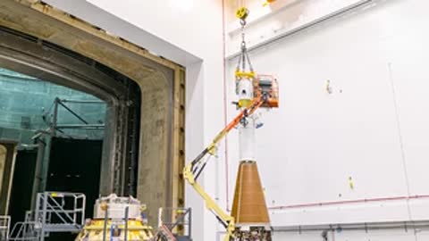 Engineers prepare Orion test article inside the high bay.