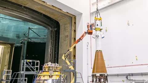 Technicians continue preparation of the Orion vehicle using lifts.