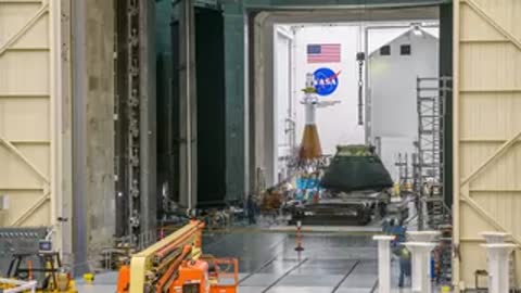 Orion capsule positioned near specialized testing stands in the facility.