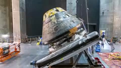 The Orion capsule is tilted on its fixture during preparation procedures.