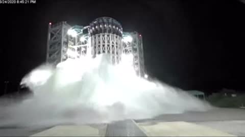 External static view of test structure undergoing violent burst test with water spray.