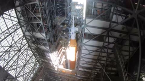 Interior view of VAB gantry with stacked rocket core stage visible.