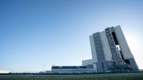 Roll out of SLS rocket on crawler transporter from VAB doors.